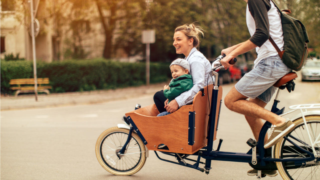 Riding a cargo bicycle with a passenger